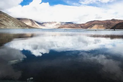 Reflections of high mountain with white cloud and blue sky on the Pagong lake Stock Photos