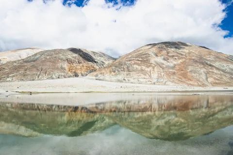Reflections of high mountain with white cloud and blue sky on the Pagong lake Stock Photos