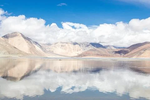 Reflections of high mountain with white cloud and blue sky on the Pagong lake Stock Photos