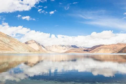 Reflections of high mountain with white cloud and blue sky on the Pagong lake Stock Photos