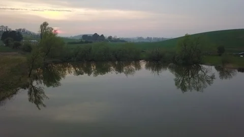 Reflections on a lake at sunset Stock Footage 108692439