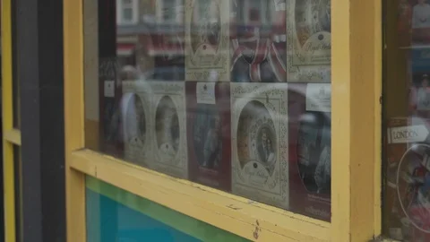 Reflections of London over Royal Wedding celebration store window Stock Footage 89880972