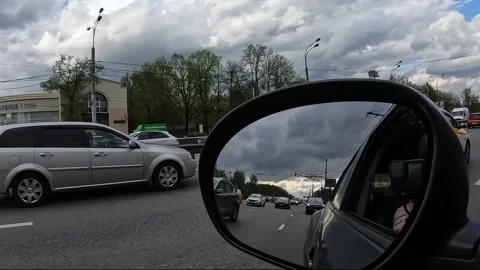 Reflections in the mirror of a moving car Stock Footage 240226199