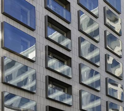 Reflections in the mirrored windows of a modern building Stock Photos