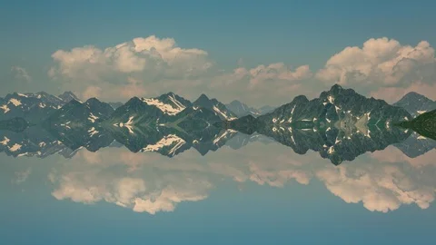 Reflections on mountain lake clouds and cliffs time lapse 스톡 동영상 91646649