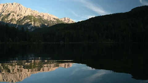 Reflections on a mountain lake in the evening Stock Footage 260868087