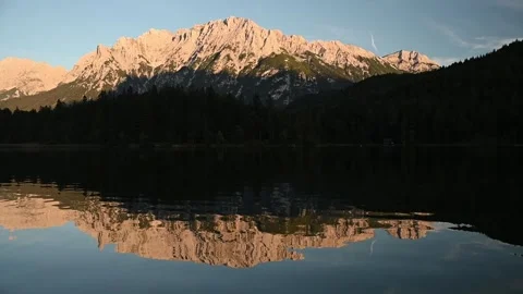 Reflections on a mountain lake in the evening Video stock 260868863