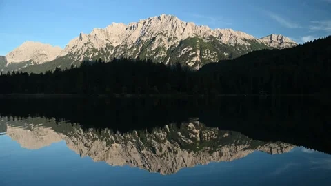 Reflections on a mountain lake in the evening with the view in rocky mountains Stock-Footage 260868373