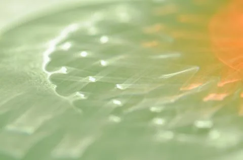 Reflections or abstract shadows from red drink in a glass on green background Foto stock