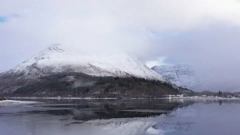 Reflections of the pap of glencoe in loch leven in winter Stock Footage