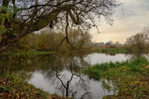 Reflections in a river with a dramatic sunset in the background. Picture from Stock Photos