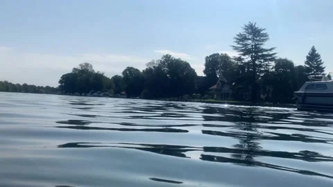Reflections on the River Thames as boat floats past Stock Footage 139623246