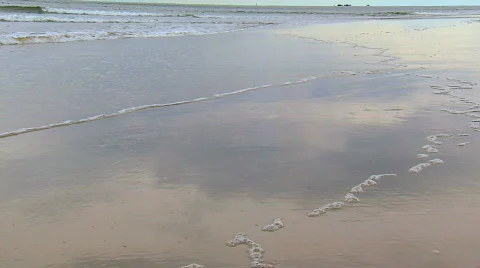 Reflections in the sand as waves are rolling in Stock Footage 538944