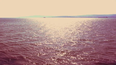 Reflections on the sea in the evening sun 動画素材 297179414