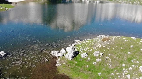 Reflections of sky, clouds and mountains in lake Stock Footage 94500675