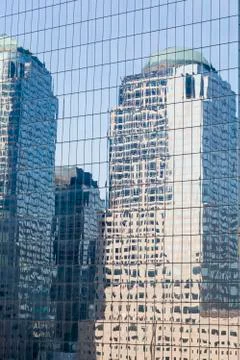 Reflections of skyscrapers in the facade of another skyscraper in manhattan Stock Photos