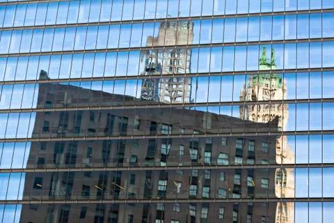 Reflections of skyscrapers in the facade of another skyscraper in manhattan Stock Photos