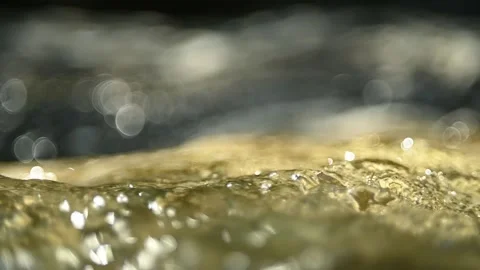 Reflections of sunlight on flowing water in a mountain river (bokeh, slow motion Stock-Footage 211755534