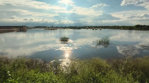 Reflections of a sunny clouded sky in a flooded farmland in madhya pradesh india Stock Footage 316289931