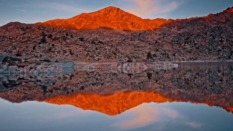 Reflections of sunset light on Pyrenees lake in Spain Stock Footage 303629966