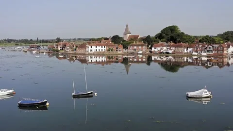 Reflections in water of Bosham Village aerial Stock Footage