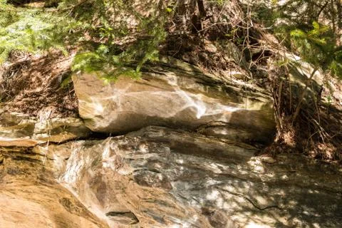 Reflections of water on the brown rocks Stock Photos