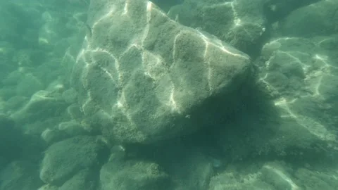 Reflections of waves on seabed stones 4k 30fps video Stock Footage 209902509