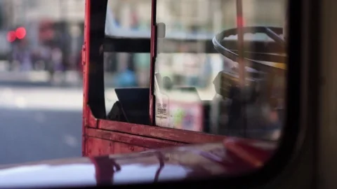 Reflections in window of classic red London routemaster bus, downtown London, UK Stock Footage 116681197