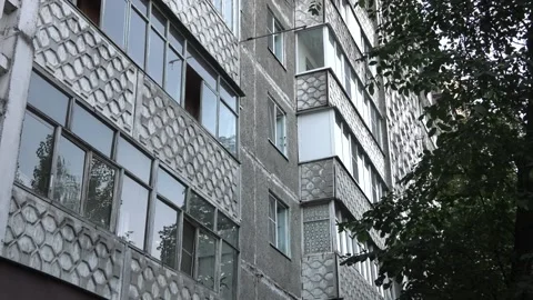 Reflections in the window glass in the old gray panel building Stock Footage 100552336