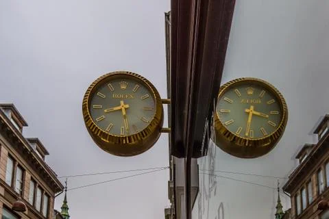 Reflections in a window of a watchmakers symbol Stock Photos