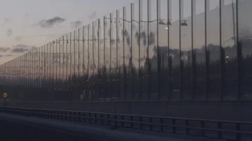 Reflections in windows by freeway in sunset Video stock 85539427