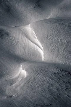 Reflections of winter light on the wind paths in the snow Stock Photos