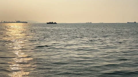 Reflection of sunlight on sea waves with container ships background Stock Footage 238422045