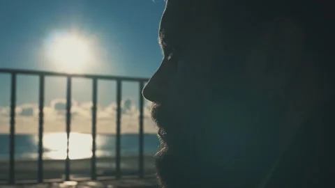 Reflective Bearded Man Embracing Sunset Solitude by the Sea Stock Footage 265594360
