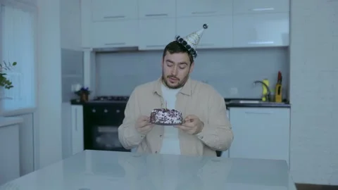 Reflective Bearded Man Marks His Birthday Alone with Cake and Candles at the Stock Footage 301720517