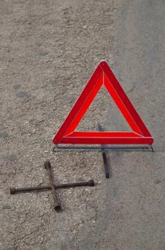 Reflective car warning triangle and tool on the road Stock Photos
