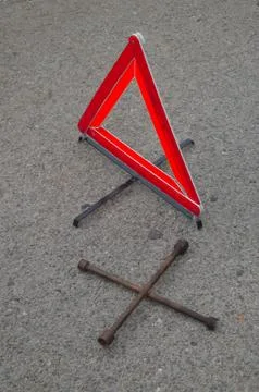 Reflective car warning triangle and tool on the road Stock Photos
