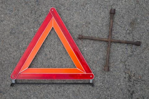 Reflective car warning triangle and tool on the road Stock Photos