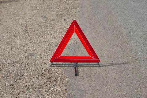 Reflective car warning triangle on the road Stock Photos