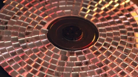 Reflective CD spins inside retro 90s player, casting shimmering light and Video stock 305574047