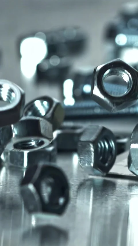 Reflective chrome wrench among assorted hardware and maintenance tools Filmed on Stock Footage 335396129