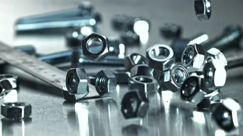 Reflective chrome wrench among assorted hardware and maintenance tools Filmed on Stock Footage 335413297