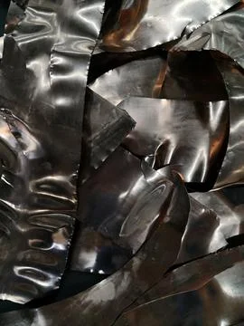 Reflective crumpled metal sheets creating distorted highlights and abstract.. Stock Photos