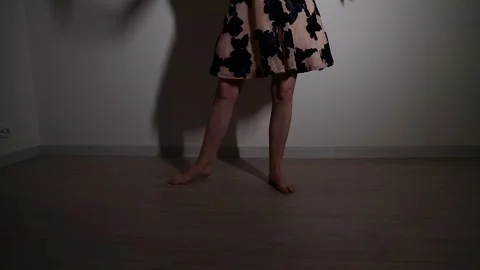 Reflective female dancer emoting through dance in dark room Stock Footage 249320765