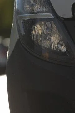 Reflective headlamp pane reveals complex light patterns and surface detail Stock Photos