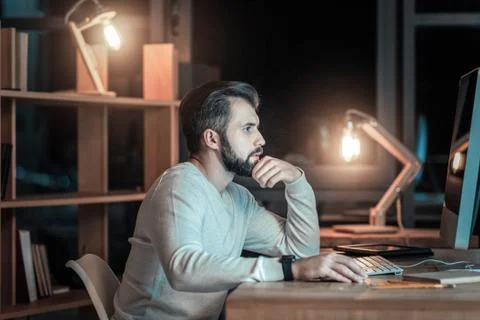 Reflective IT guy selecting code Stock Photos