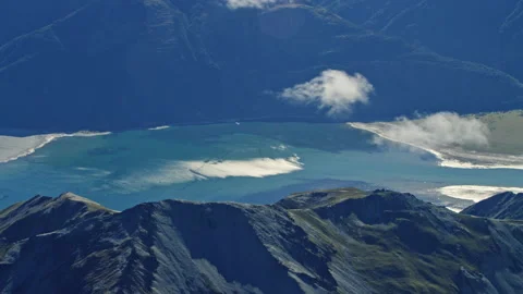 Reflective lake with clouds and mountains aerial fly by Stock Footage 155484257