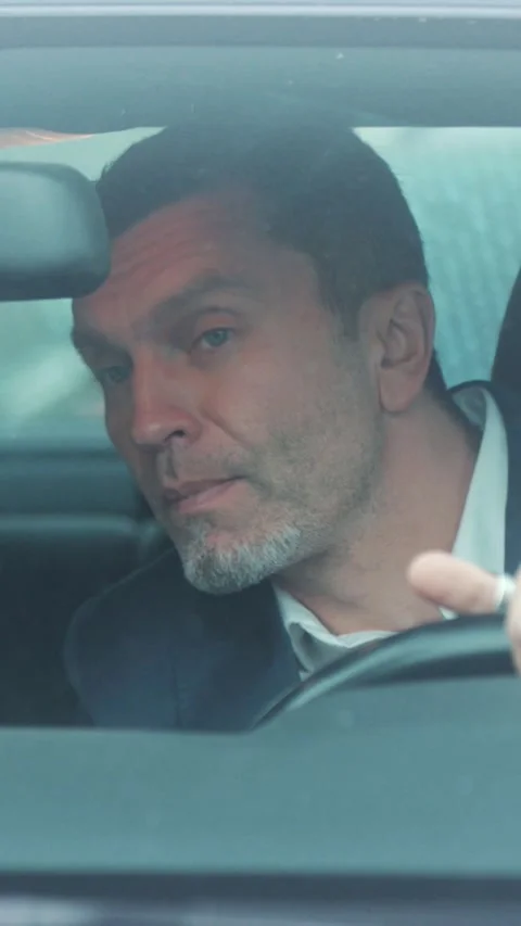 A reflective man contemplates life while driving through the bustling city Stock Footage 316528266