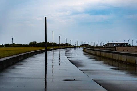Reflective Pathway on a Calm, Cloudy Day Stock Photos