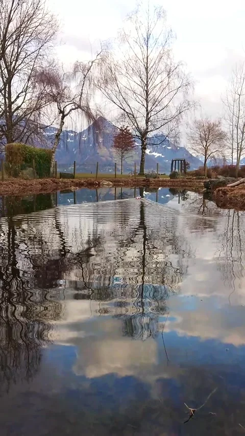 Reflective Pond Scene with Model Boat and Mountain View Stock Footage 292026680